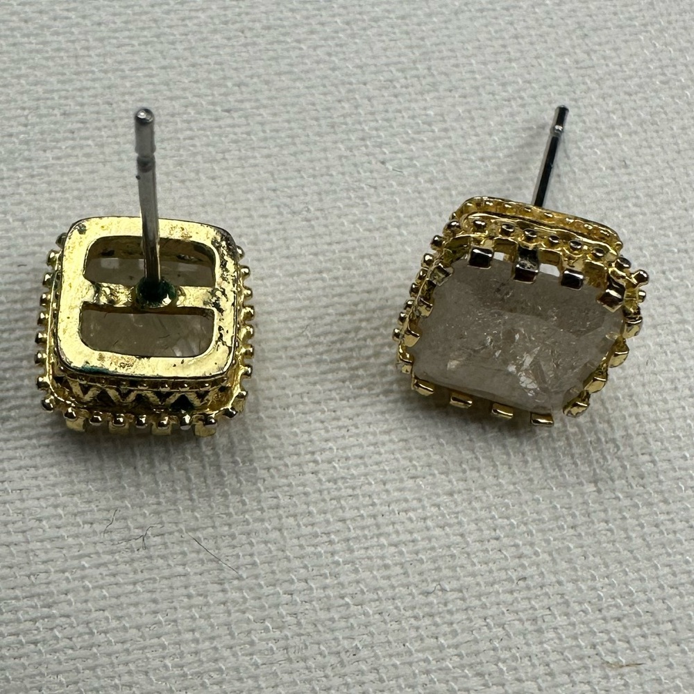 Faux gold stud earring with iridescent white/pearly faux gem. No backs to studs.